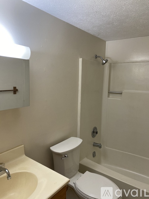 A bathroom with a toilet, sink, and bathtub.