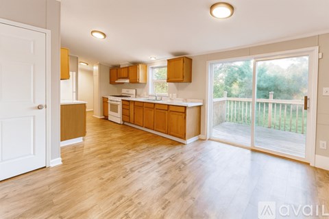 A kitchen with wooden floors and cabinets is available for rent.