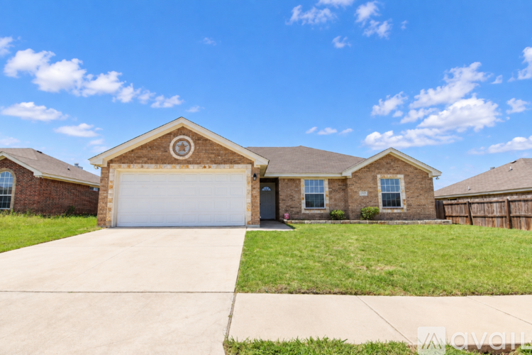 A house with a garage door and a driveway in front.