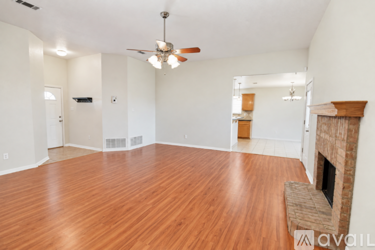 A spacious living room with hardwood floors and a fireplace.