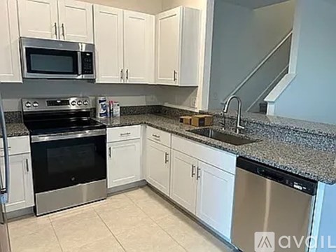 A kitchen with granite countertops and stainless steel appliances.
