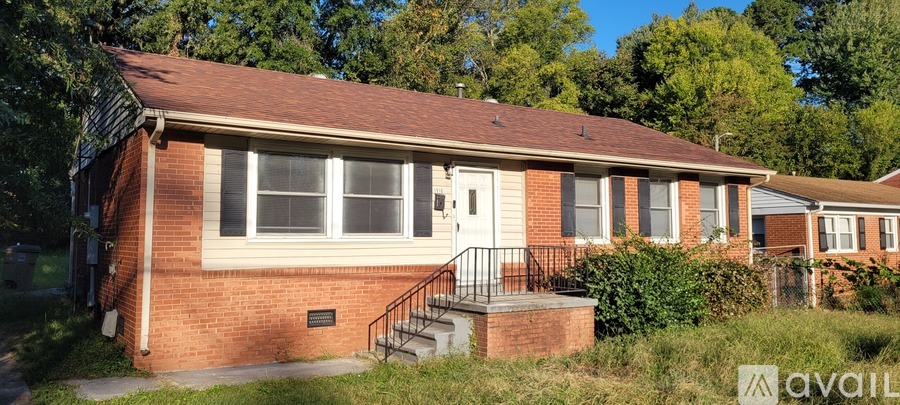 A small red brick house with a white door and a window.