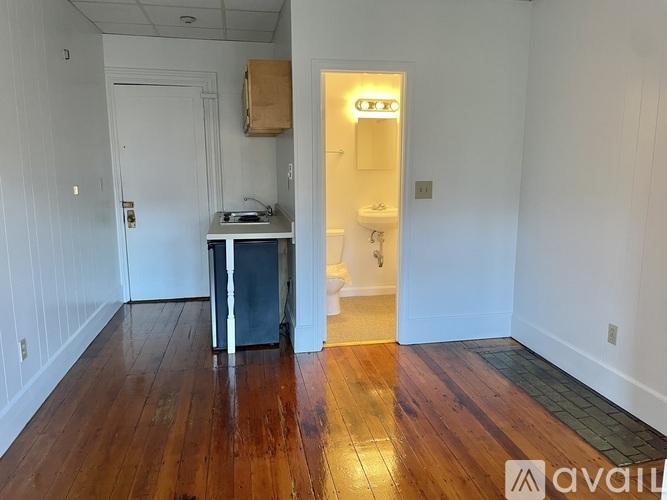 A room with wooden floors and a white door.