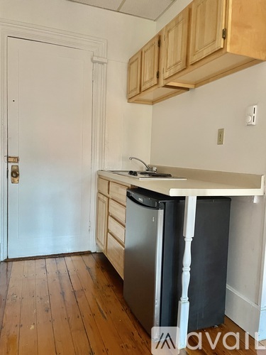 A kitchen with wooden cabinets and a white countertop.