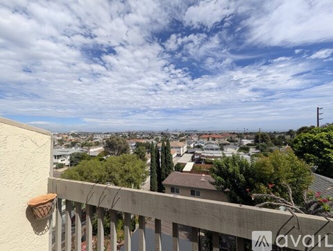 A balcony with a view of a residential area.