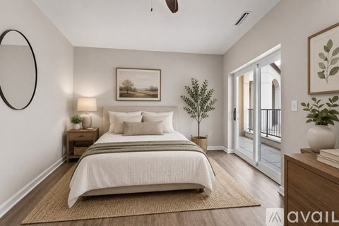 A bedroom with a large bed, a nightstand with a lamp, and a painting on the wall.