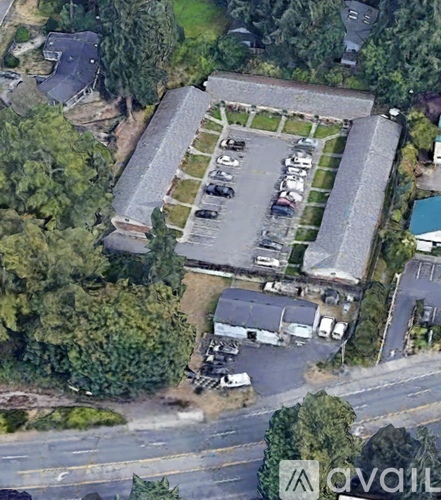 An aerial view of a parking lot with cars and a building.