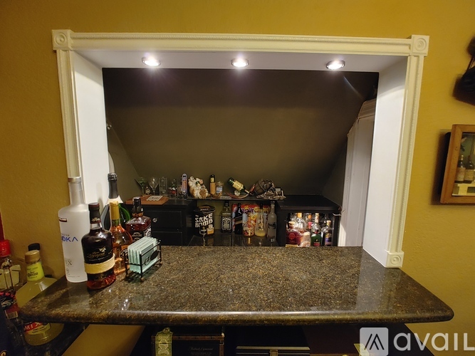 A kitchen counter with various bottles and containers on it.