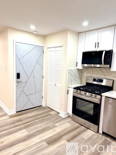 A kitchen with a stove top oven and microwave.