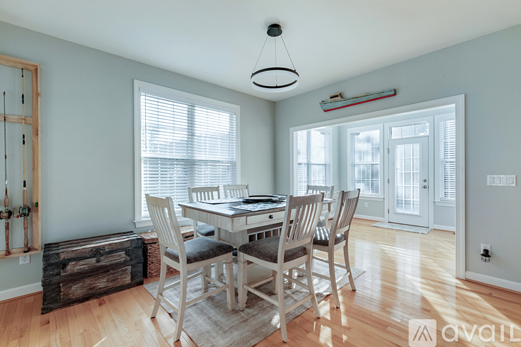 A dining room with a wooden table and chairs.