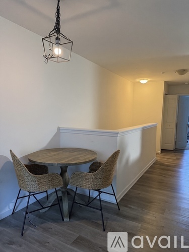 A room with a round table and chairs.