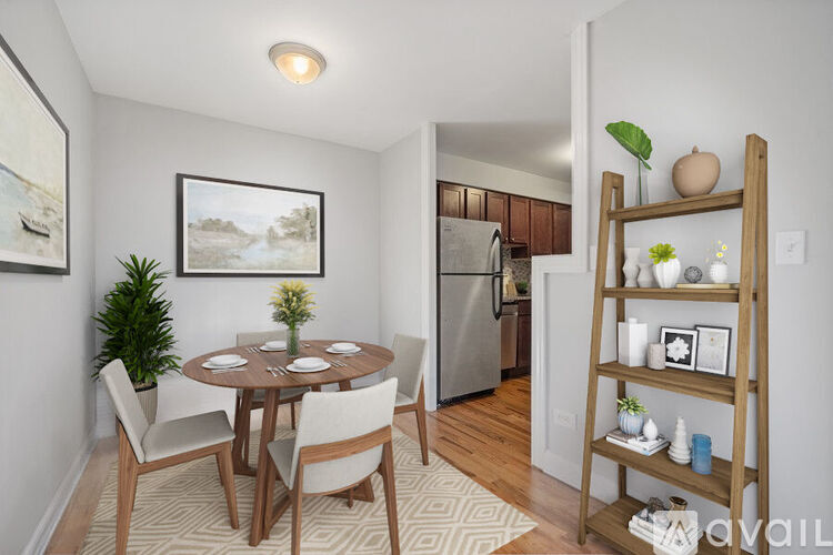 A dining room with a wooden table and chairs.
