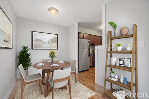 A dining room with a wooden table and chairs.