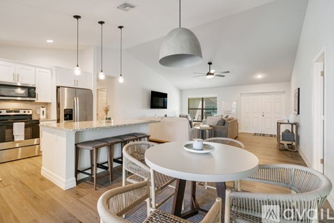 A modern kitchen with a breakfast table and chairs.