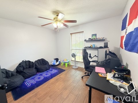 A room with a blue rug on the floor that says "ROOM".