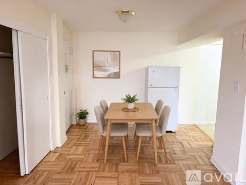 A dining room with a wooden table and chairs.
