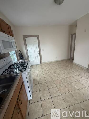A kitchen with a stove top oven and a microwave.