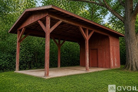A wooden pavilion with a brown roof and a red door is surrounded by greenery.