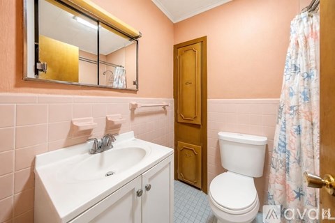 A bathroom with a sink, toilet, and shower.