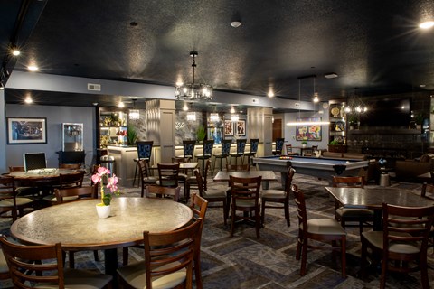 A restaurant with tables and chairs and a pool table.