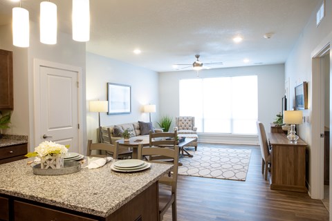 A well-lit dining room with a table set for a meal.