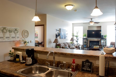 A kitchen with a sink and a counter.