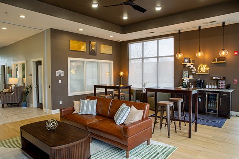 A living room with a brown couch and a wooden coffee table.