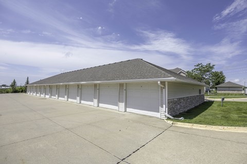 A large building with a grey roof and white garage doors.