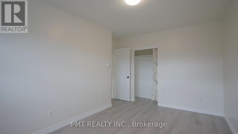 A white room with a doorway leading to another room.