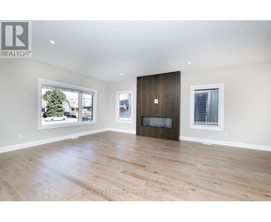 A spacious room with a fireplace and a large window.