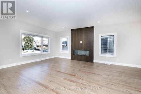 A spacious room with a fireplace and a large window.