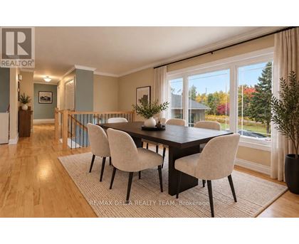 A dining room with a table and chairs.