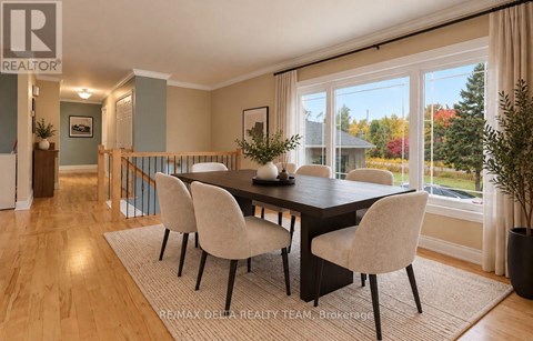A dining room with a table and chairs.