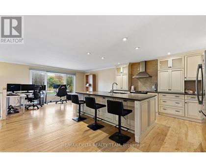 A well-lit kitchen with a dining table and chairs.