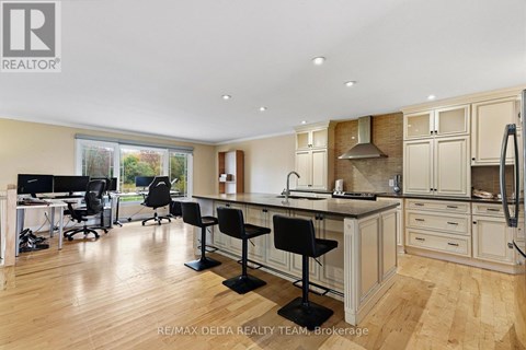 A well-lit kitchen with a dining table and chairs.