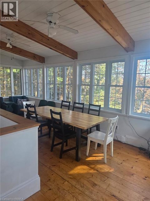 A dining room with a wooden table and chairs.
