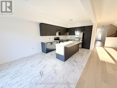 A modern kitchen with a marble floor and wooden cabinets.