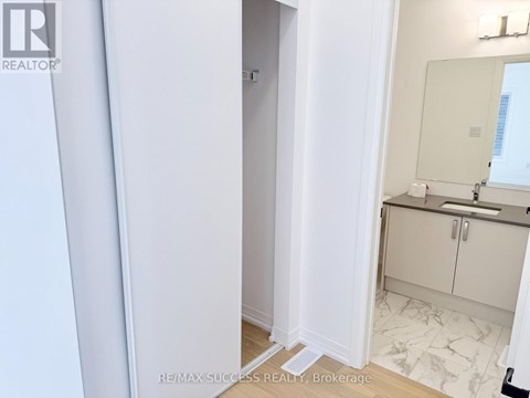 A bathroom with a sink, mirror, and cabinets.