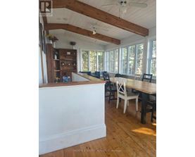 A dining room with a wooden table and chairs.