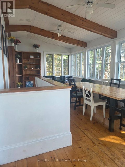A dining room with a wooden table and chairs.