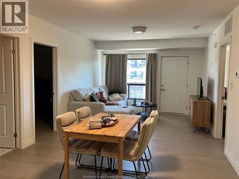 A living room with a dining table and chairs.