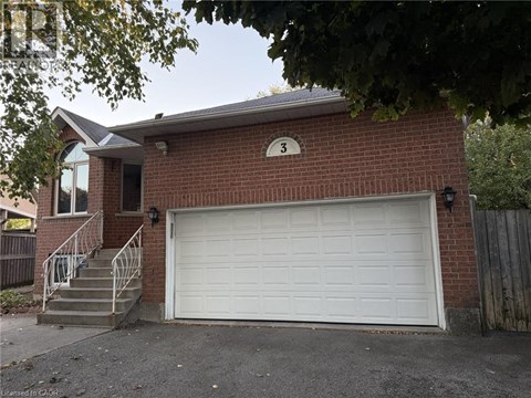A red brick house with a white garage door and number 3 on the wall.