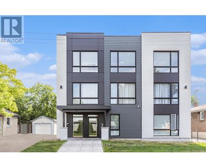 A modern two-story building with a realtor logo on the top left corner.