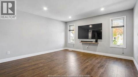 A spacious room with a television and a window.