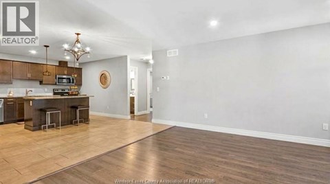A realtor's office with a kitchen area in the back.