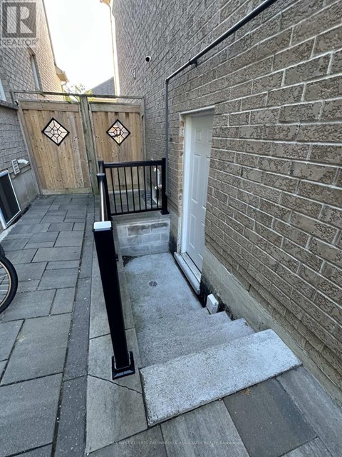 A black metal railing is on a concrete staircase.