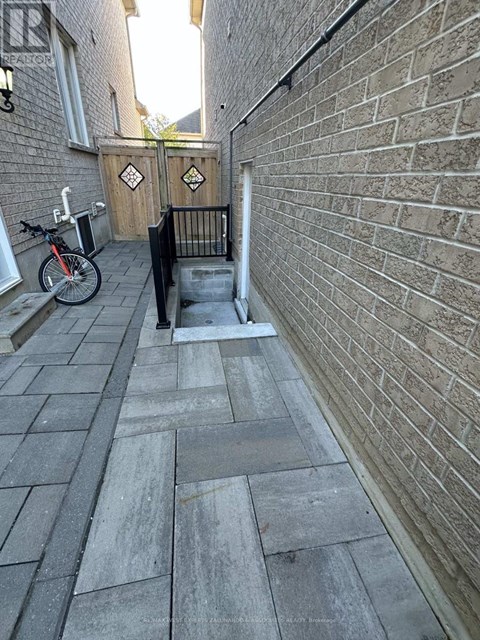 A bicycle is parked next to a brick wall.