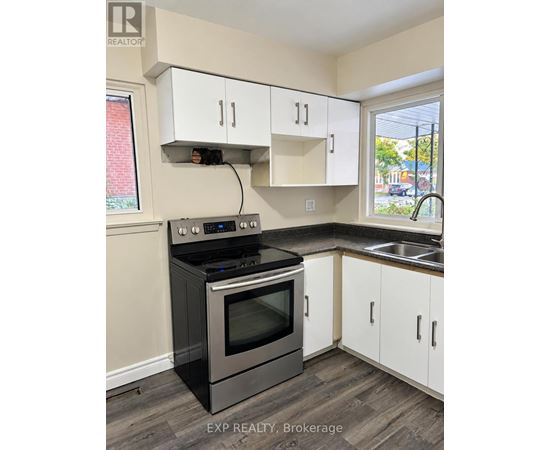 A kitchen with a stove and cabinets.