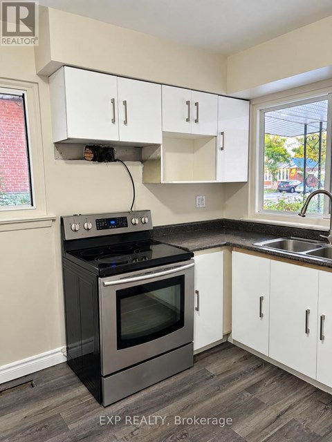 A kitchen with a stove and cabinets.