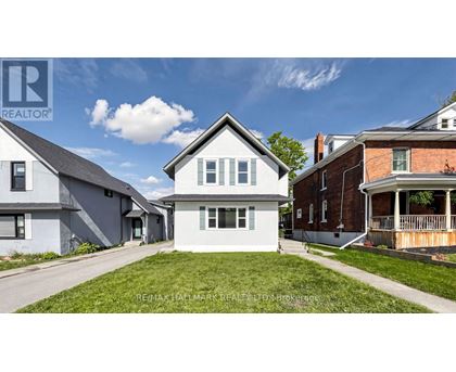 A house with a lawn in front is for sale.